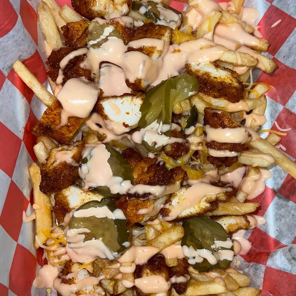 Cali Burrito's loaded fries with crispy chicken, melted cheese, pickled jalapeños, and creamy sauce.