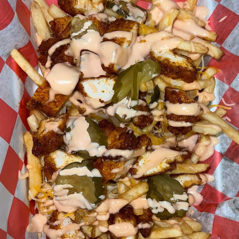 Cali Burrito's loaded fries with crispy chicken, melted cheese, pickled jalapeños, and creamy sauce.
